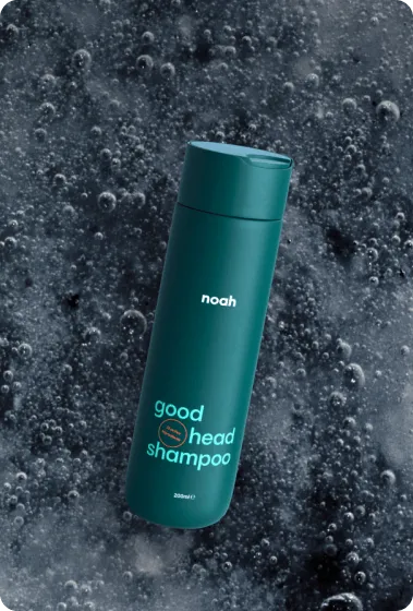 Noah Good Head Shampoo teal bottle on dark bubbly water background for OTC sale