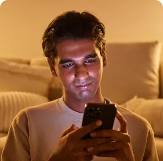 A man at home answering questions on his phone