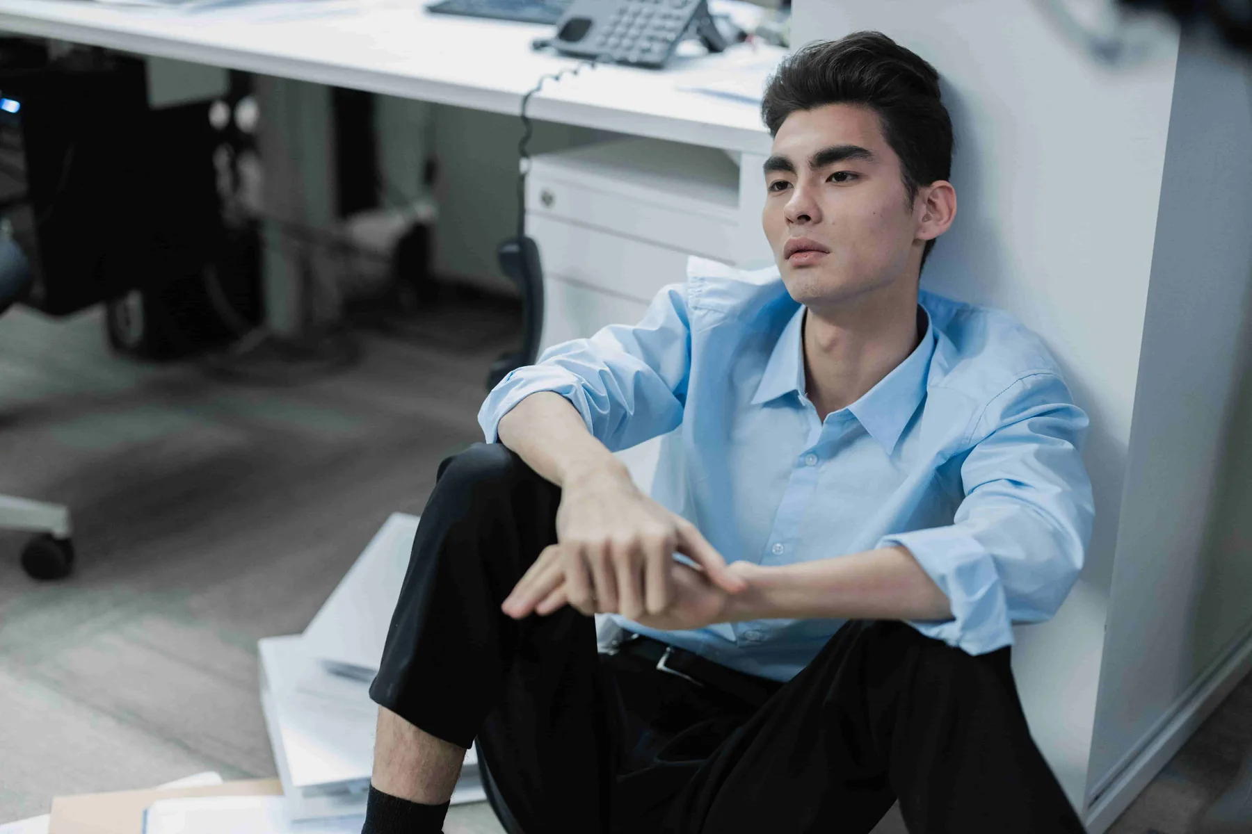 A man sitting by his desk deep in thought