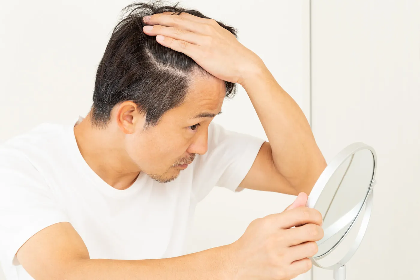 A man touching his hair