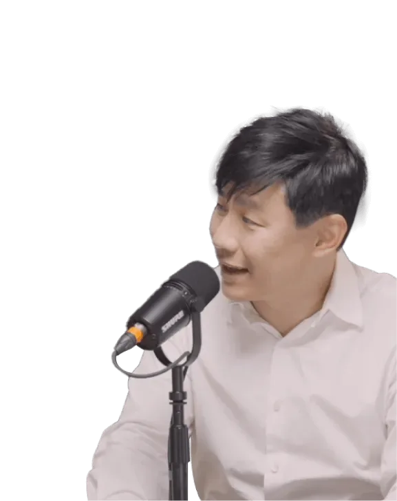A podcast guest laughing as he speaks into a microphone