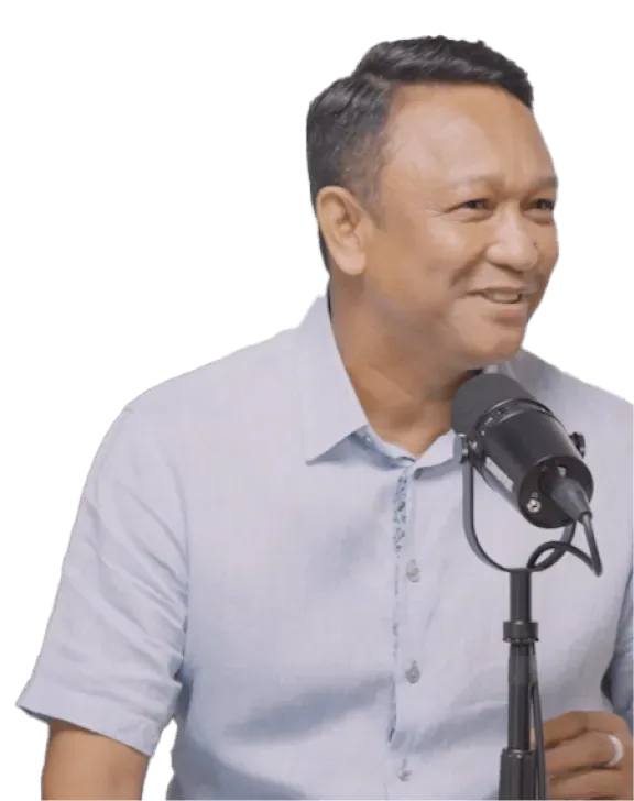 Fandi Ahmad smiling as he speaks into a podcast microphone