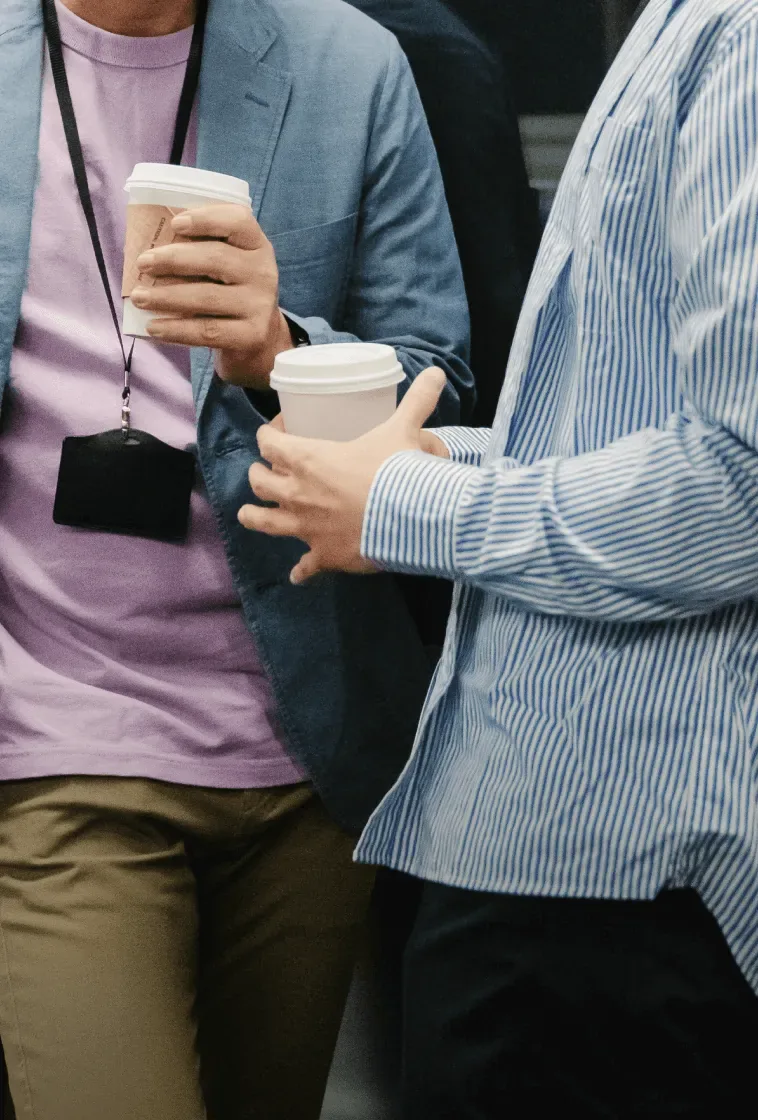 Two men chatting with coffee after work