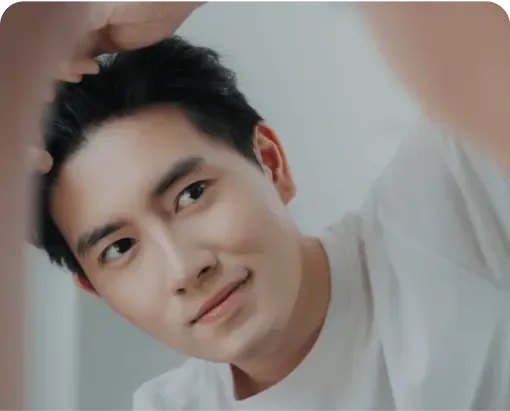 Young man running a hand through his hair