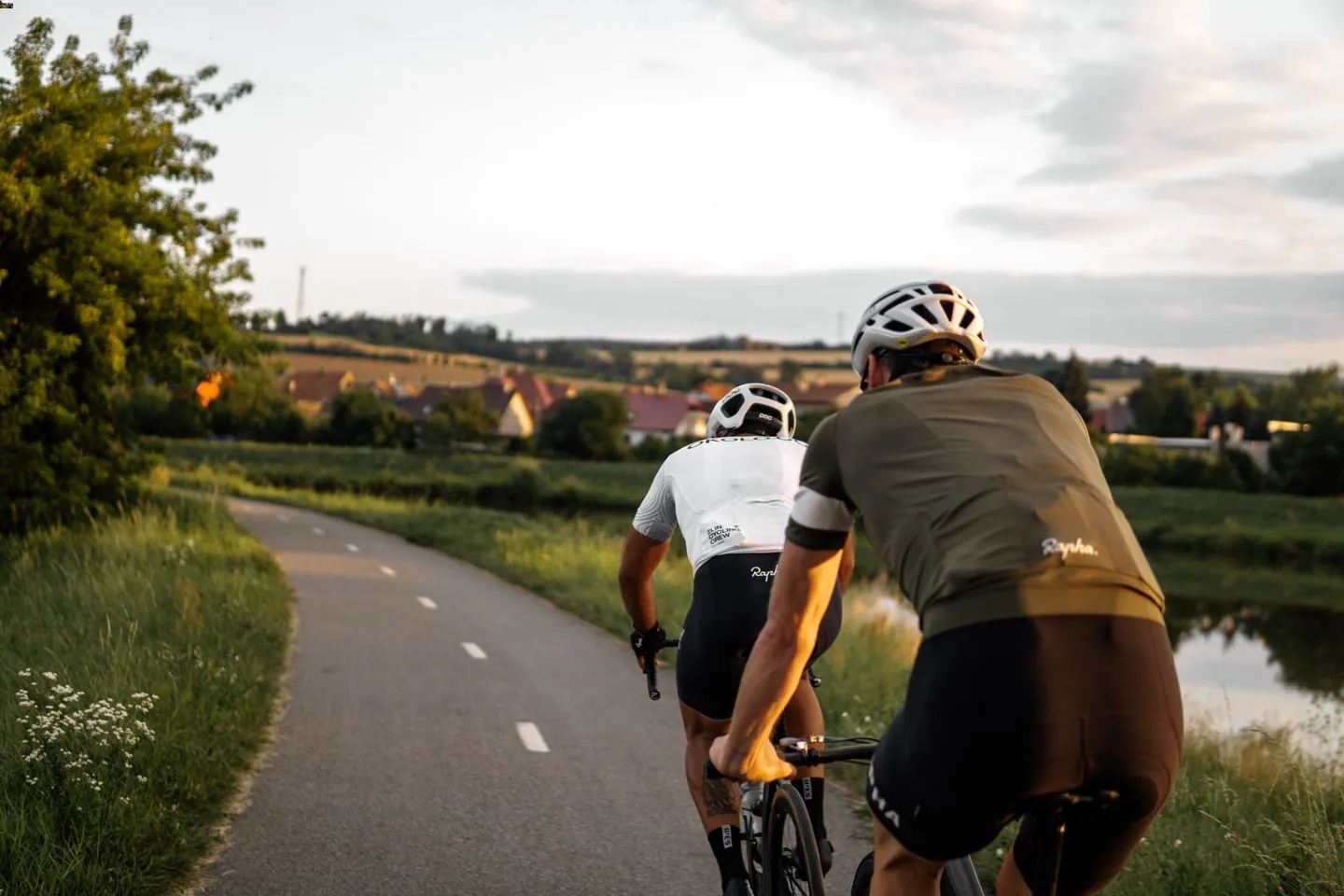 Two men cycling during the afternoon at a scenic location