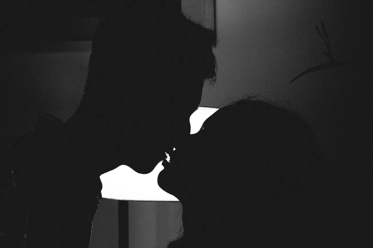 A couple kissing in the dark