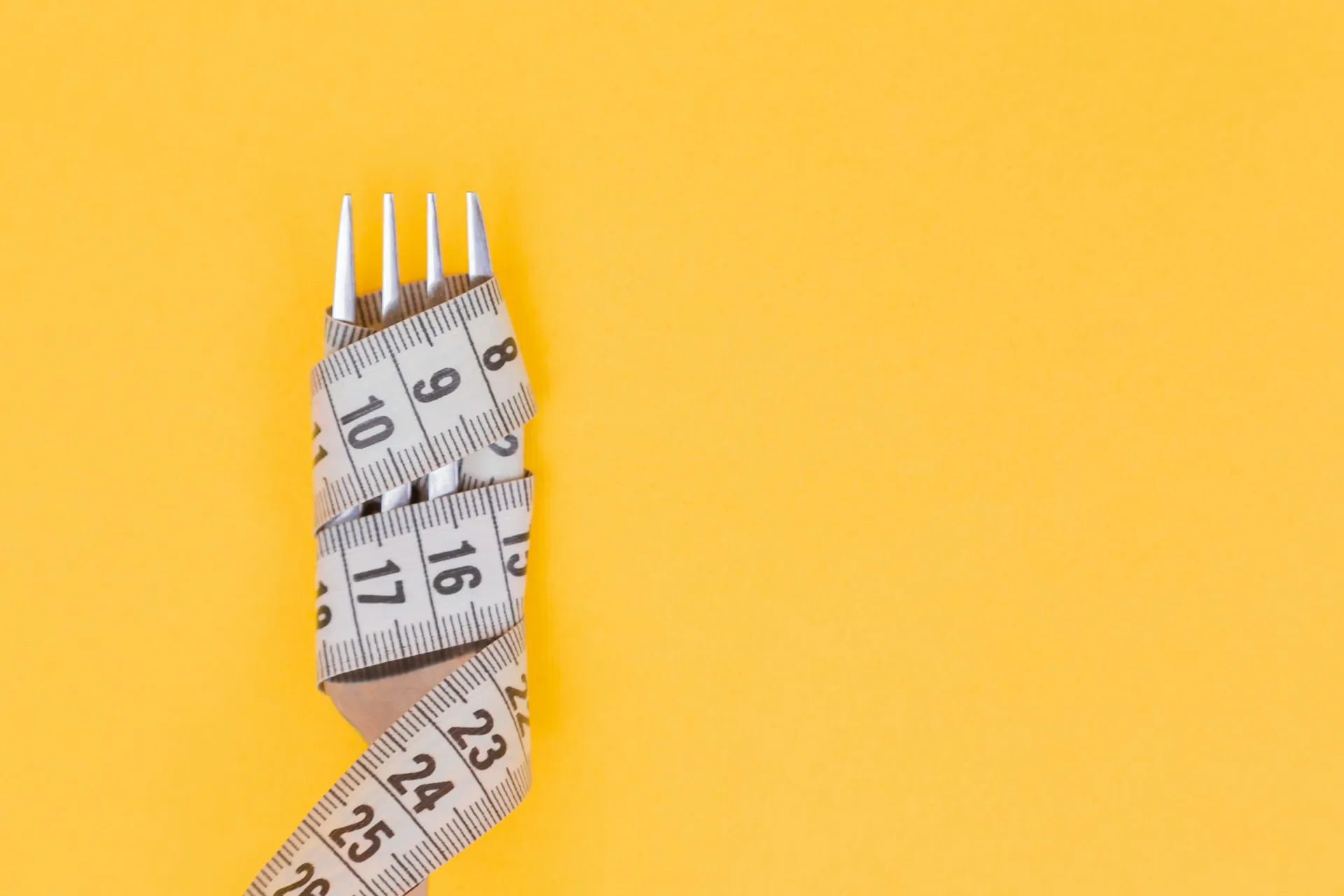 A fork wrapped with measuring tape