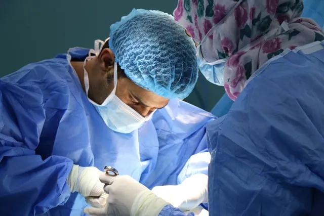 A male surgeon performing a surgery