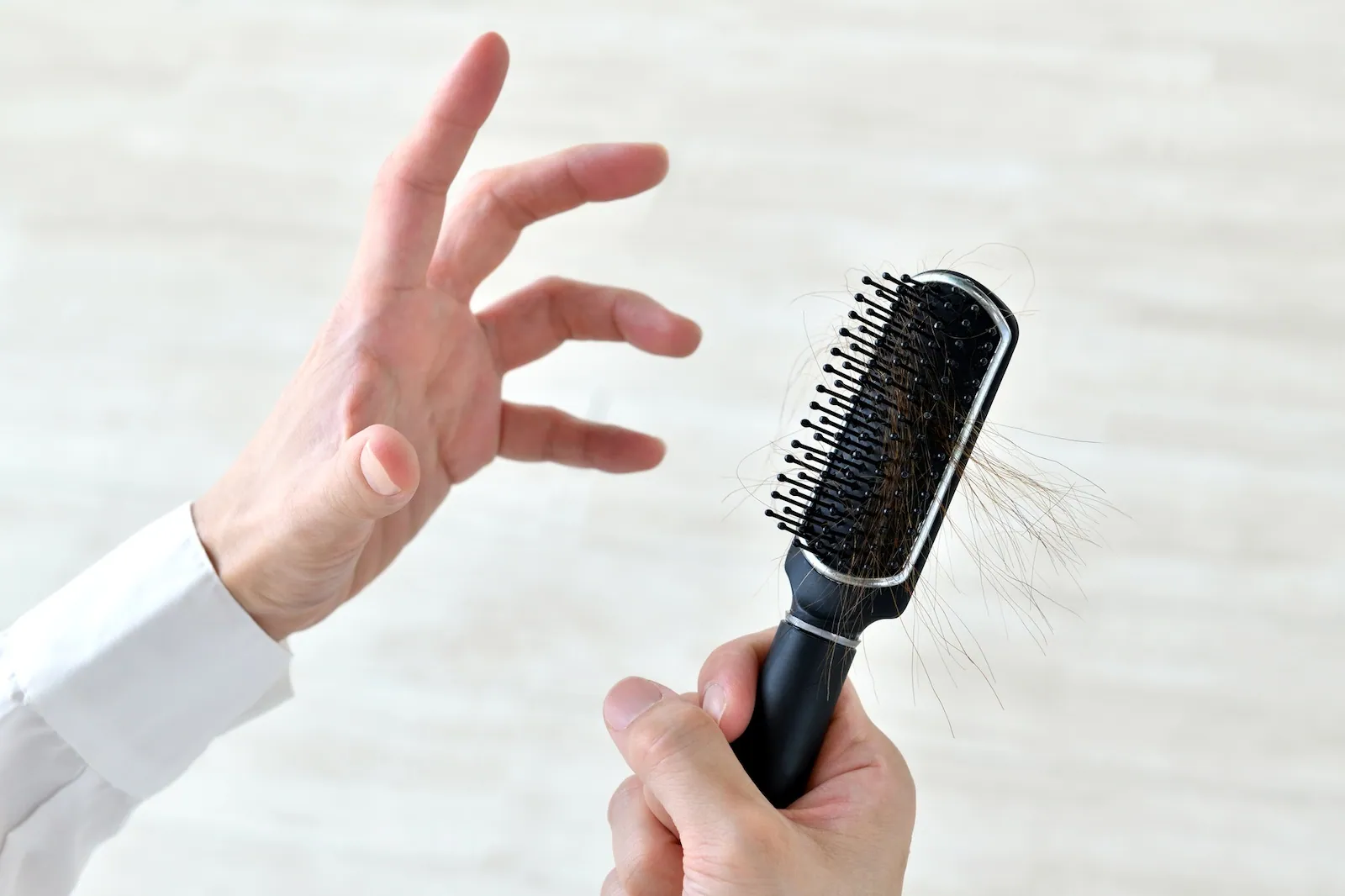 Multiple strands of thin hair stuck to a brush