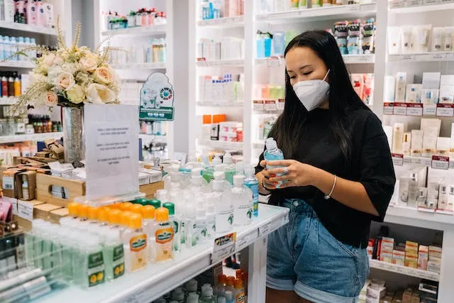 Singaporean woman browsing through soaps at a pharmacy