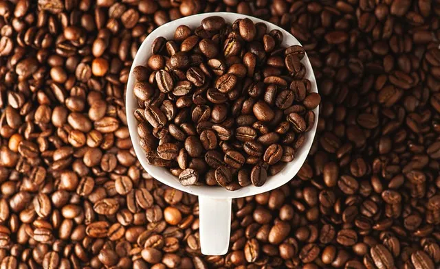 A giant scoop filled with coffee beans