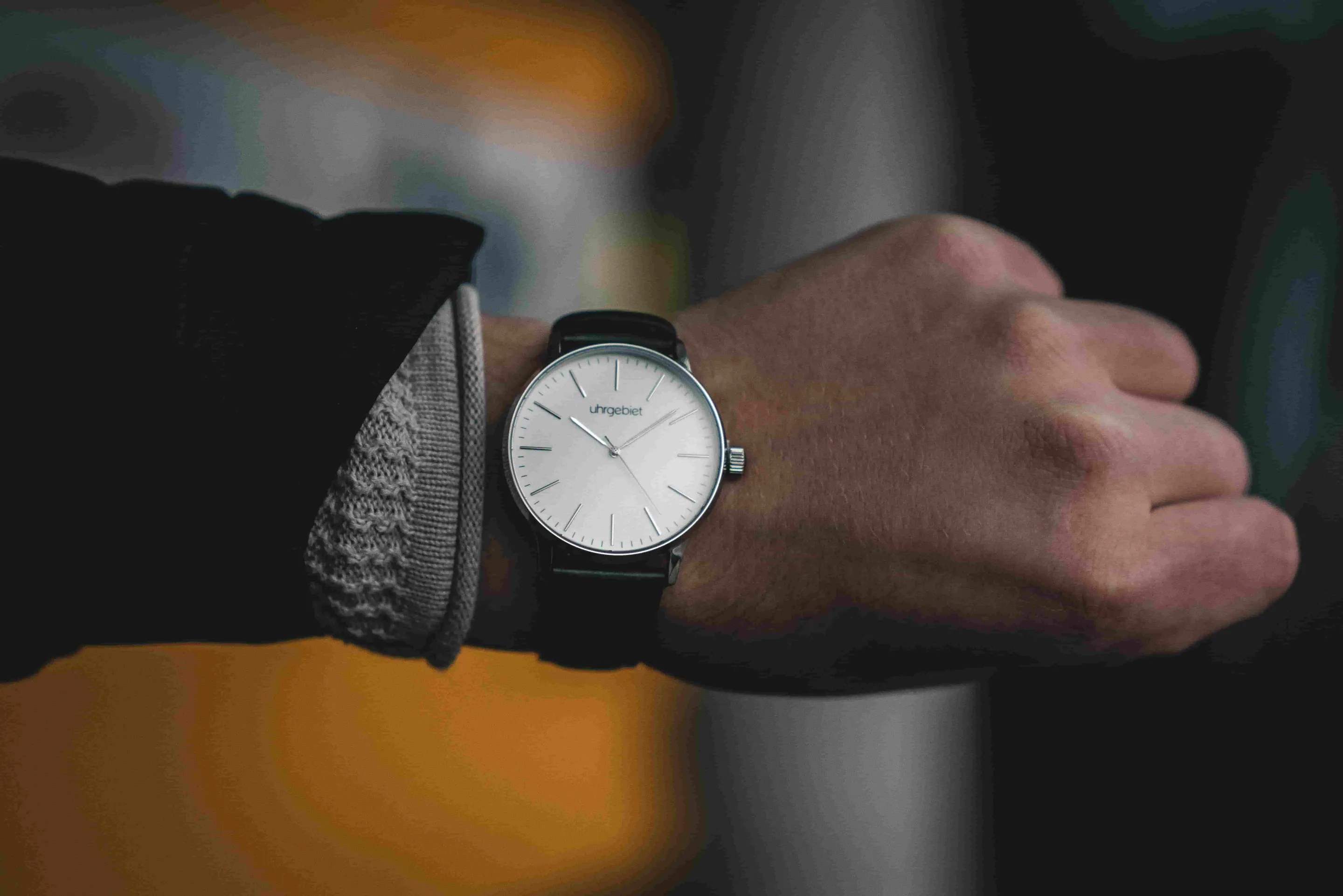 Closeup of a minimalist-style wristwatch on a man's left arm