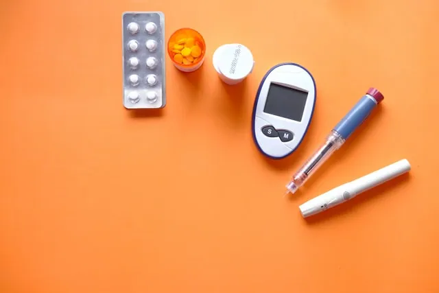 A collection of medical devices against an orange background